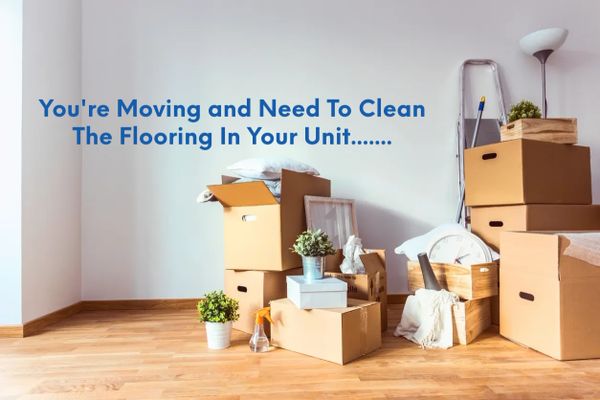 Packed moving boxes and cleaning supplies in a room needing floor cleaning.