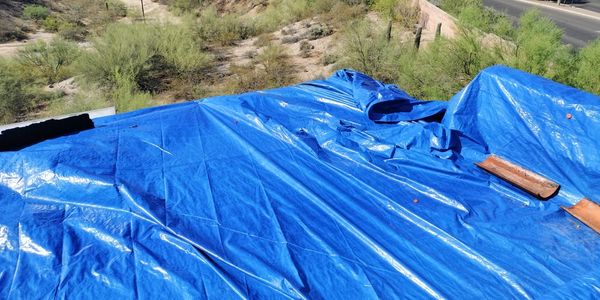 Roof being tarped 