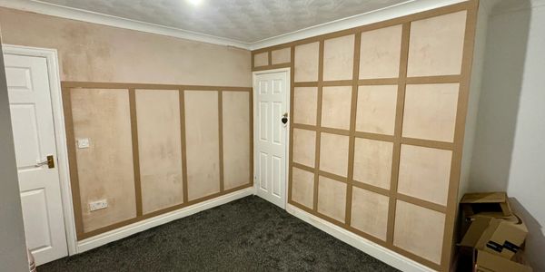 Room walls with wooden paneling under renovation.