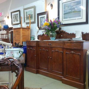 Antique wooden furniture and decorative items in a cozy room.