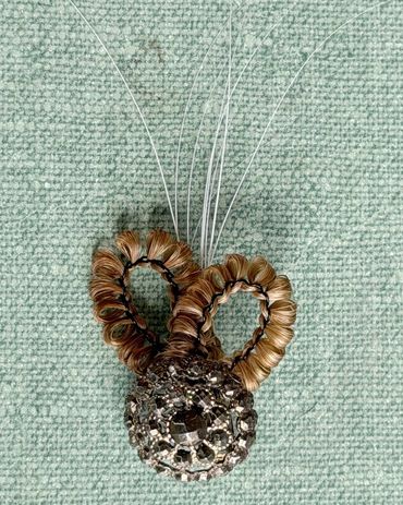 Brooch made with human hair, cat whiskers, vintage button