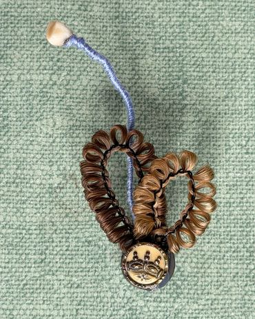 Magnet made with human hair, baby tooth and vintage button