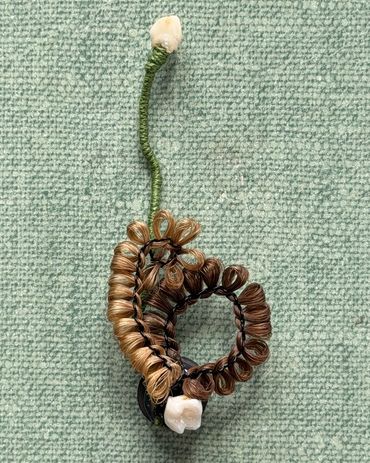 Magnet made with human hair and baby teeth