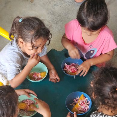 Group of children eating at a small table