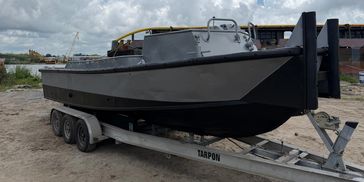 Black boat on a trailer.