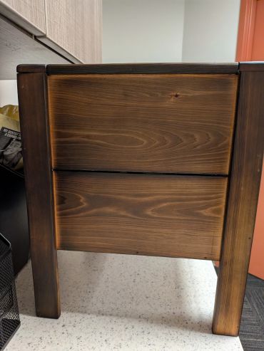 Wooden drawer unit with a natural finish and visible wood grain.