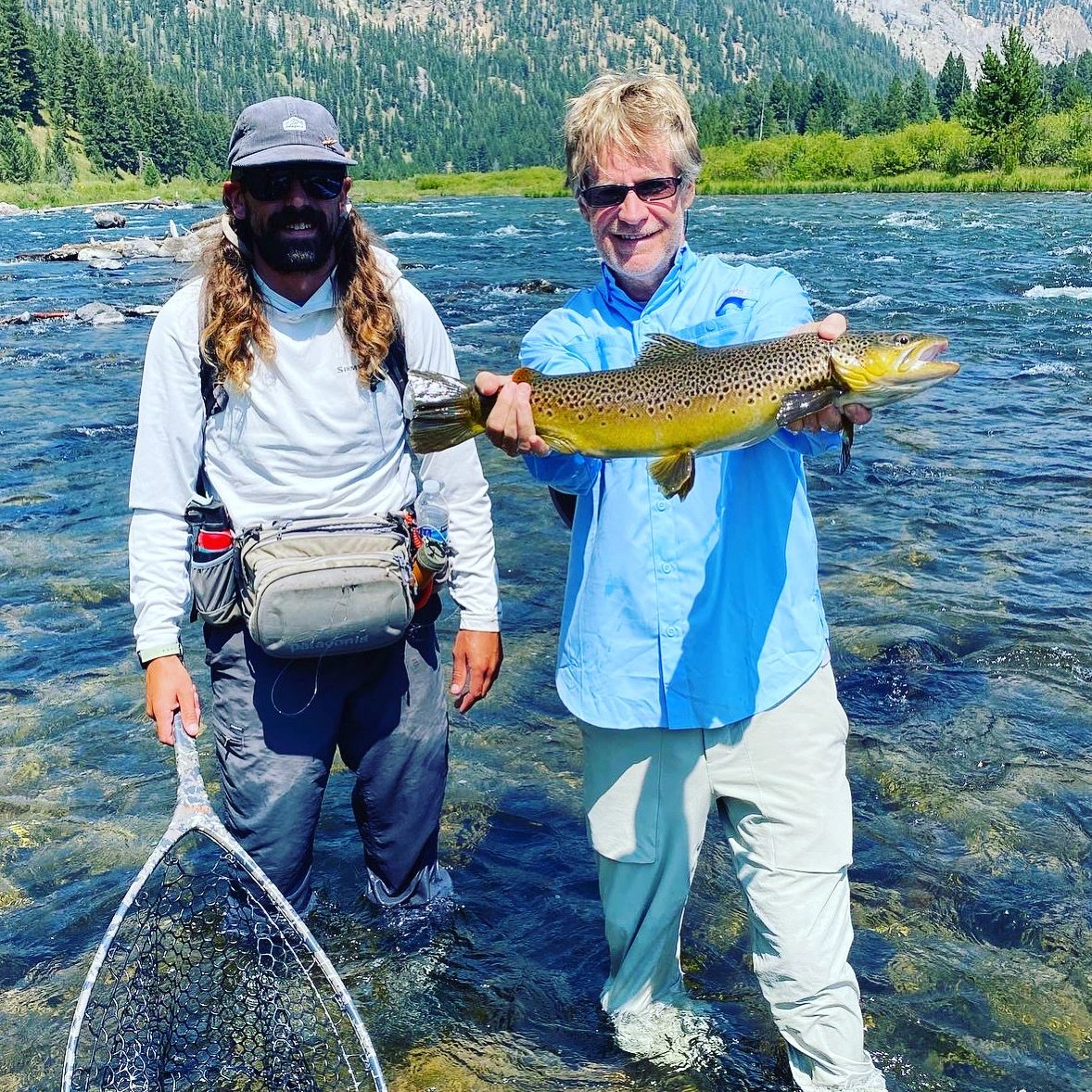 Jake Schilling fly fishing guide with a brown trout near Hebgen Dam, Upper Madison River, Montana.