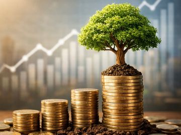Stacked coins growing into a tree with a rising financial graph in the background.