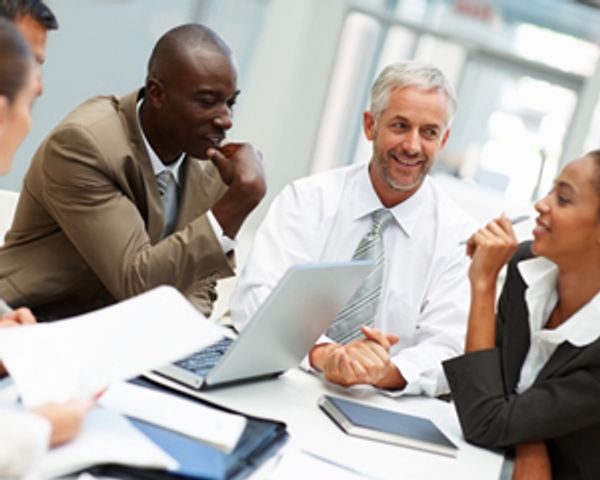 Business team collaborating around a meeting table.







