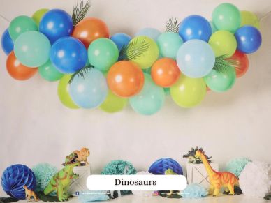 Colorful dinosaur-themed party setup with balloons and decorations.