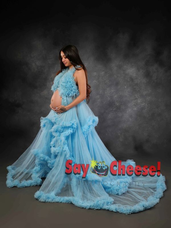 Pregnant woman in a flowing blue gown.
