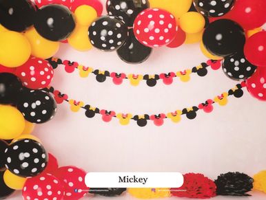 Colorful Mickey-themed party decorations with polka dot balloons and garlands.