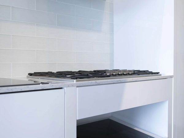 Minimalistic furniture installed by TKB Group, featuring stylish tiles for a clean, modern look.