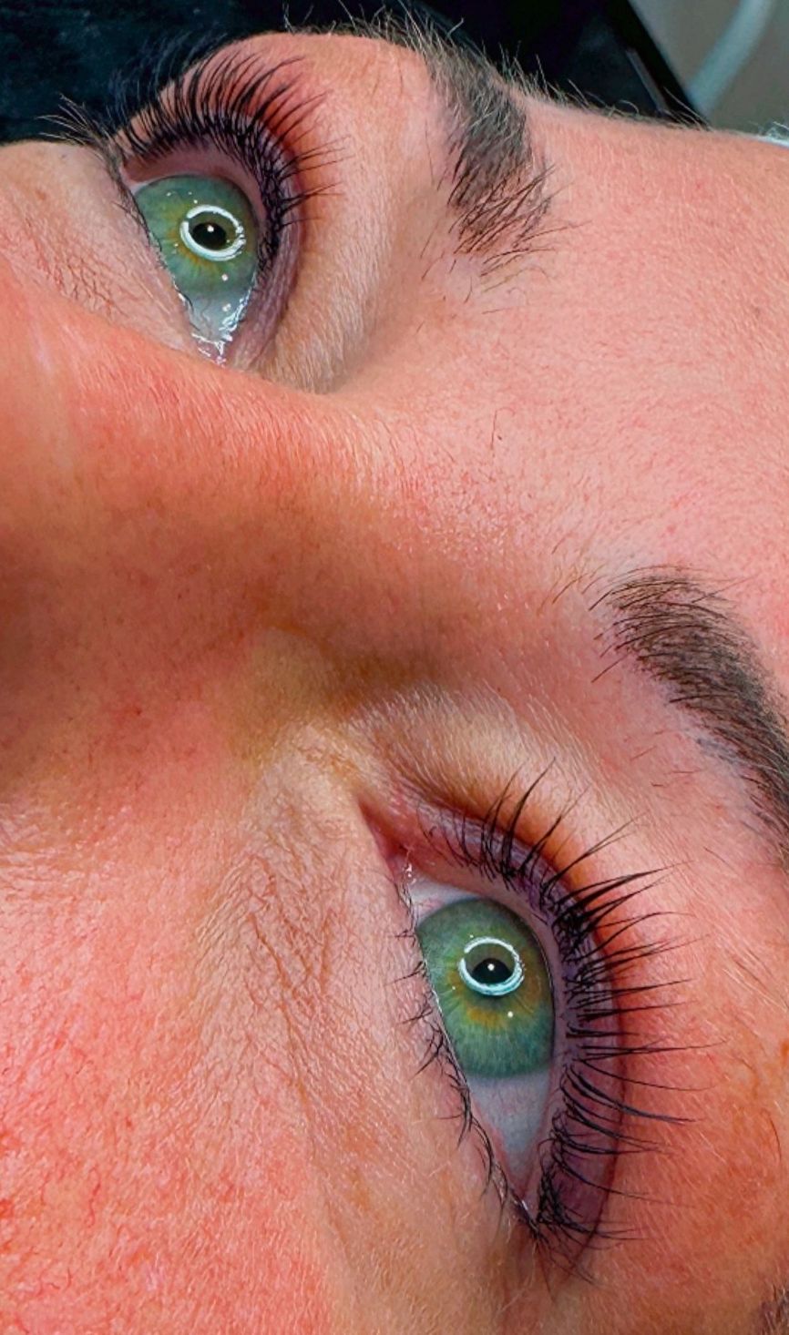 Close-up of Korean lash lift green eyes with detailed eyelashes and skin texture.