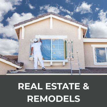 Painter refurbishing a house exterior under a bright blue sky.