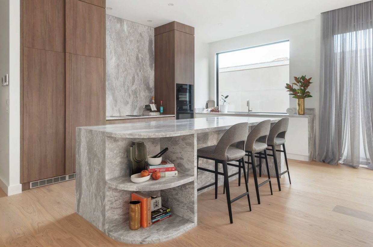 High-end kitchen with marble island bench and backsplash designed by Dana Meadows Architect