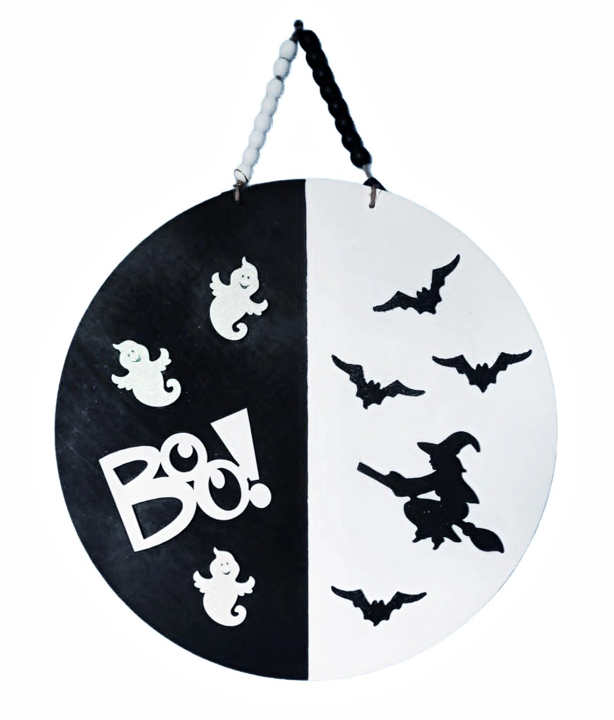 Black and white Halloween door hanger with ghosts, bats, and witch.