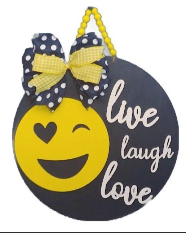 Emoji face with heart eye and bow saying live laugh love.
