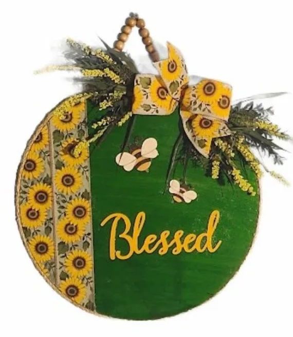 Decorative sign with sunflowers and the word Blessed.