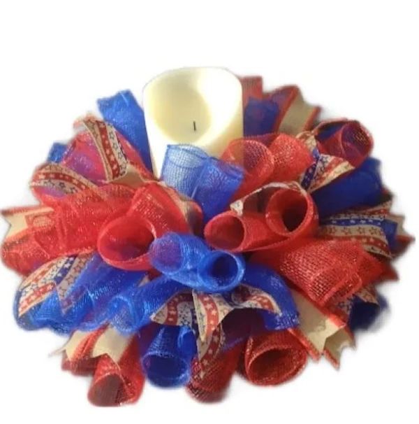 Patriotic candle wreath with red, white, and blue ribbons.