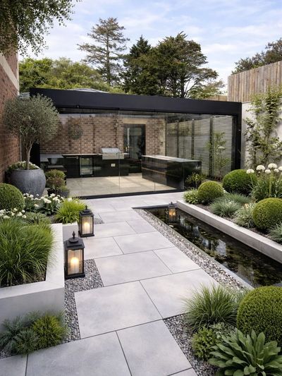 Modern garden designed and built to create a luxury outdoor living space with pergola and kitchen.