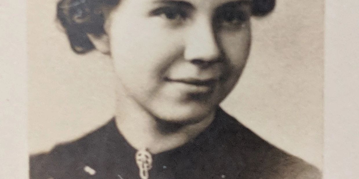 Vintage photo of a young woman with a slight smile.