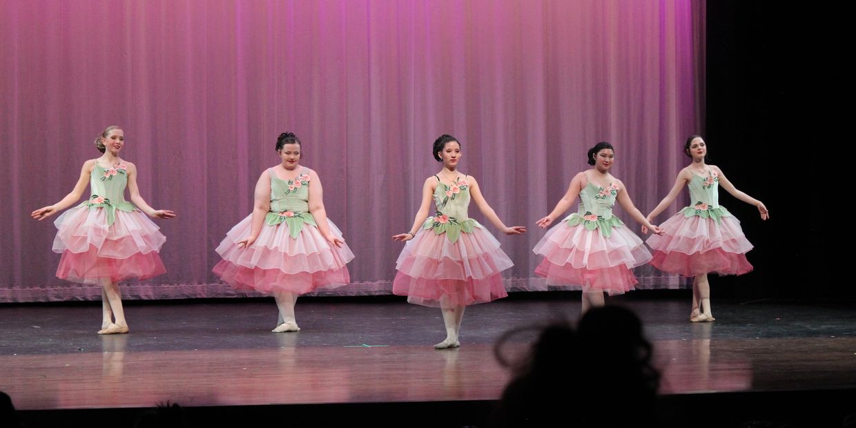 Ballet dancers on pink tutus on stage