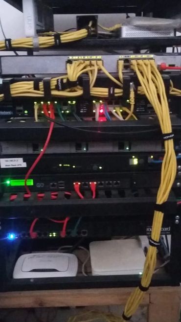 Network server rack with organized yellow and red cables.