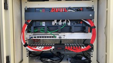 Organized network server rack with neatly arranged cables and equipment.