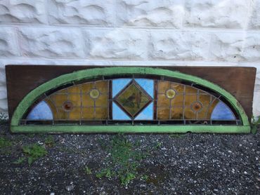 Colorful stained glass window panel with geometric patterns.