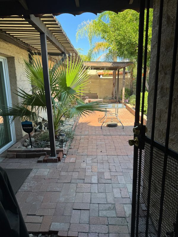 A scenic view of mountains with a clear blue sky and a lake in the foreground.