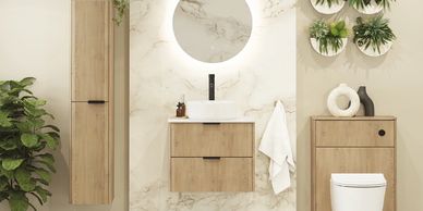 Modern bathroom with wood cabinetry, round mirror, and green plants.