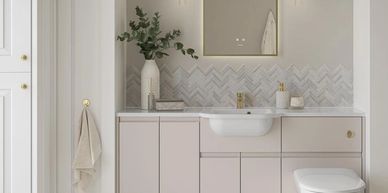 Modern bathroom with beige cabinets, a white sink, and gold accents.