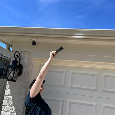 Inspecting a gutter as part of a complete roof inspection for hail damage