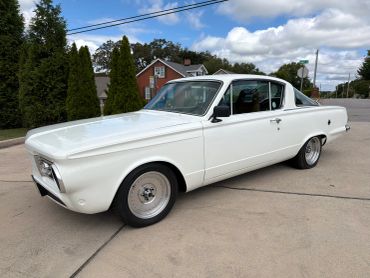 Classic white vintage car parked on a driveway.