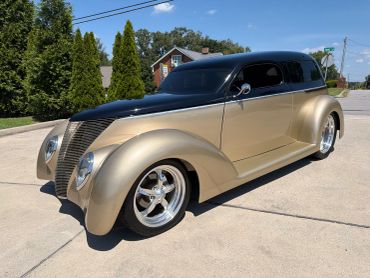 Custom classic car with black and gold paint.