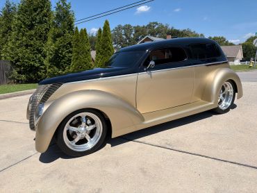 Classic two-tone custom car parked outdoors.