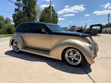 Classic customized vintage car with chrome wheels.