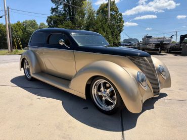 Classic two-tone vintage car parked under a sunny sky.