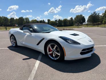 White convertible sports car parked outdoors.