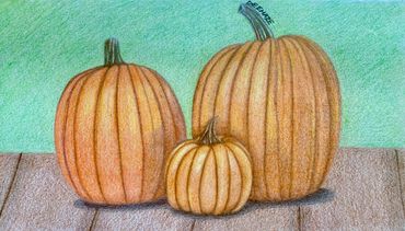 Group of three pumpkins on a brown deck