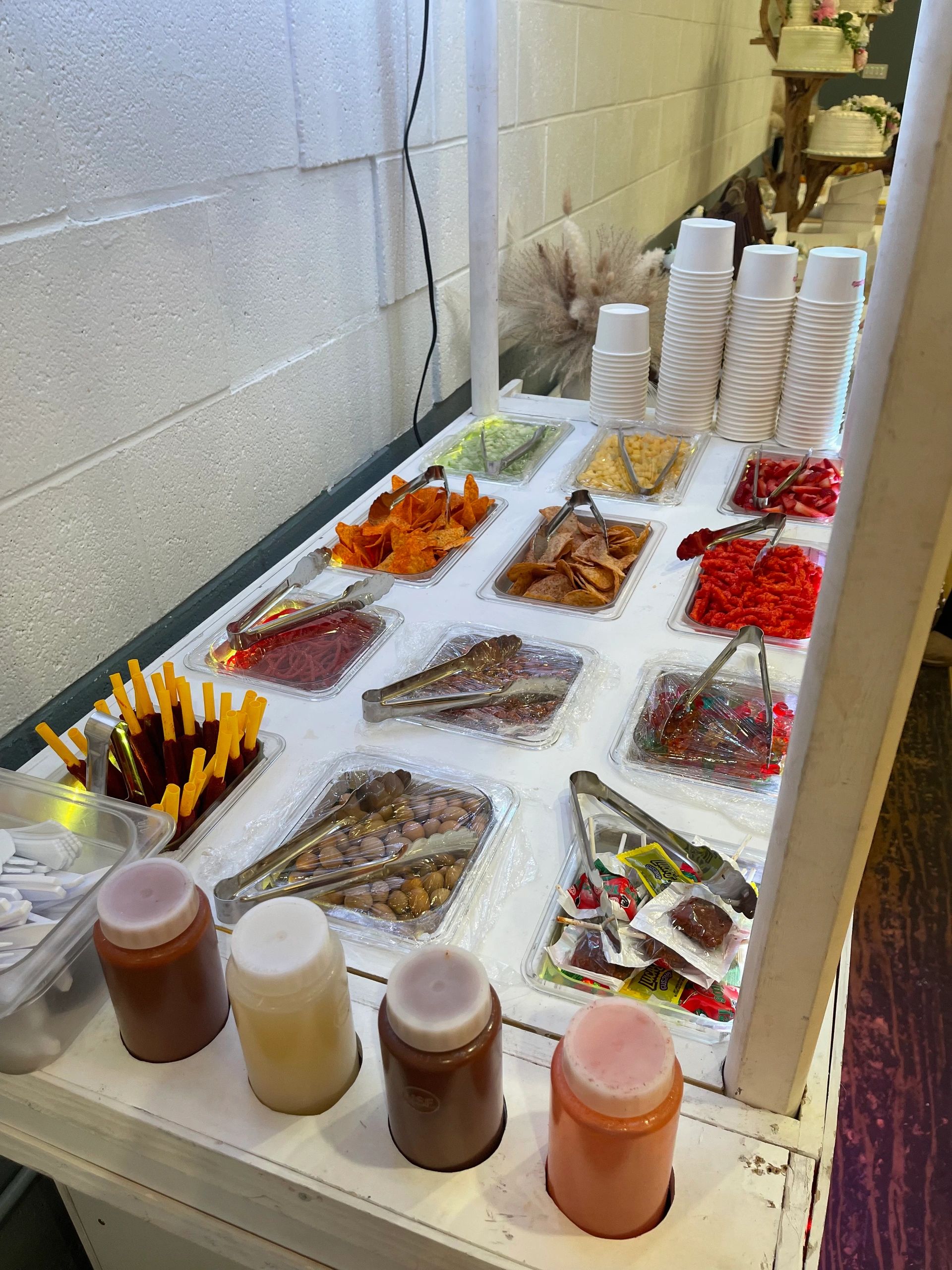 Snack and sauce buffet with chips, candies, and dipping sauces.