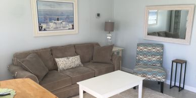 Cozy living room with brown sofa and patterned chair.