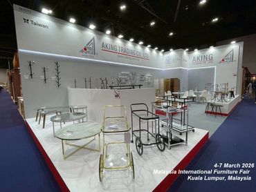 Modern furniture displayed at the Aking Trading Co. Ltd booth in a large exhibition hall.