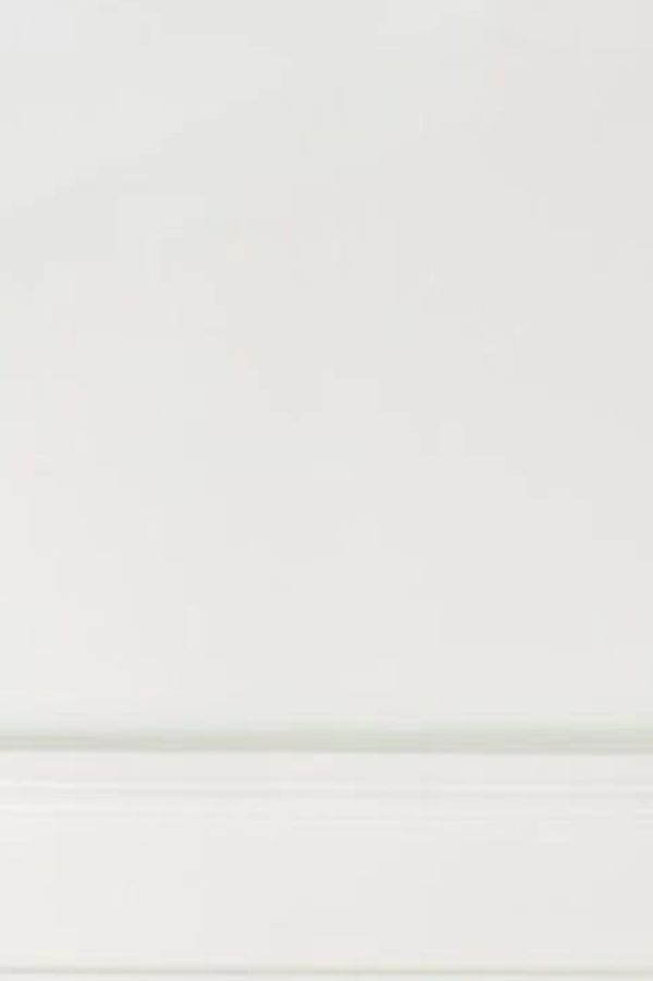 Minimalist white wall with simple molding detail.