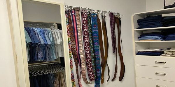 Master Closet Organization with neatly organized shirts and pants in Wilmington, NC
