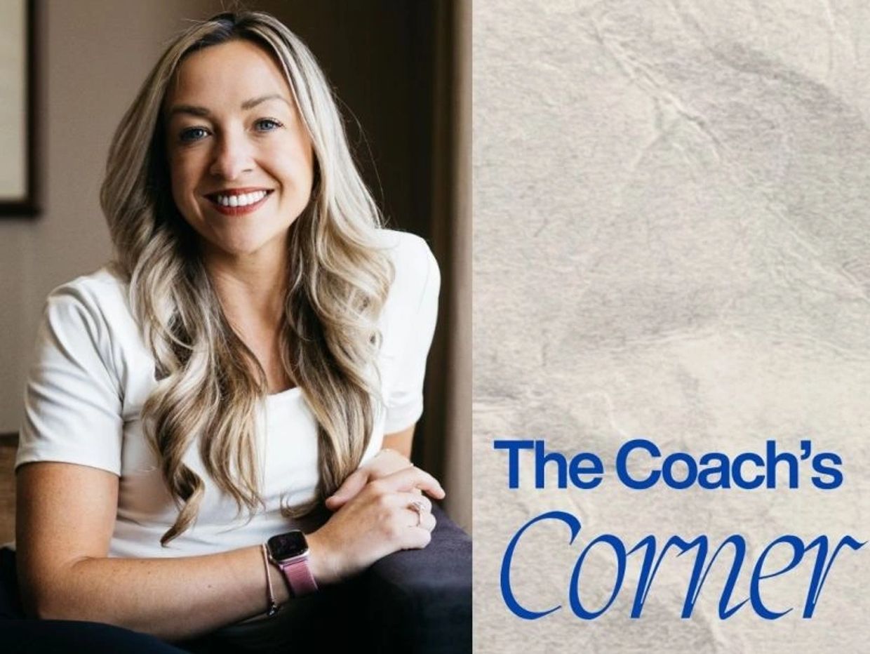 Smiling woman with long hair next to text, 'The Coach's Corner'.