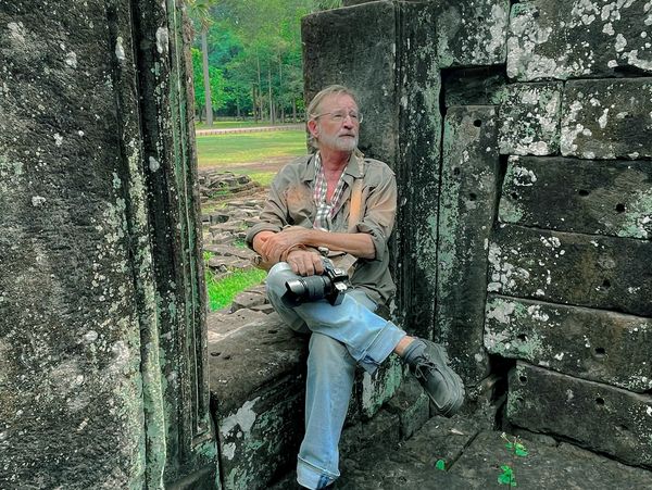 Fred Sigman sitting at Angkor Wat. 