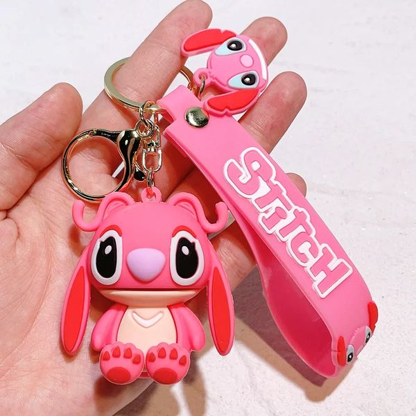 Pink Stitch keychain and strap held in hand.