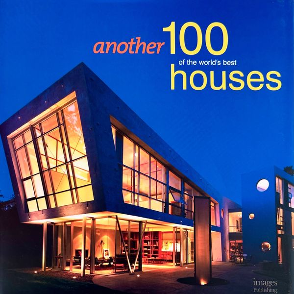 Modern illuminated house with large glass windows at dusk.